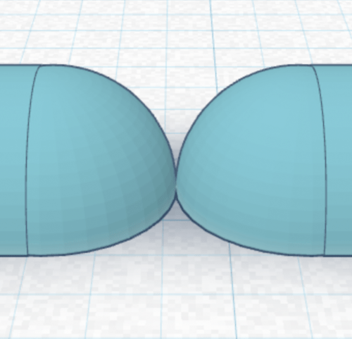 Two round shapes with a flat bottom. The peak of the round shape on the flat side is touching the other one. 
