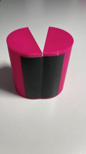 A cylinder made of two halves joined with a piece of adhesive tape (Tesa cloth tape) as a hinge.