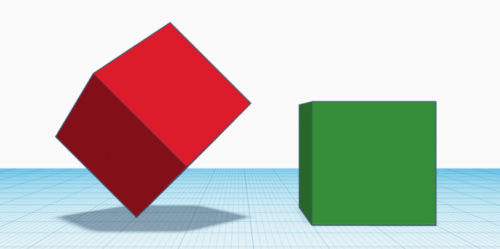 Two cubes with one balancing on a corner and the other one on flat on the surface.