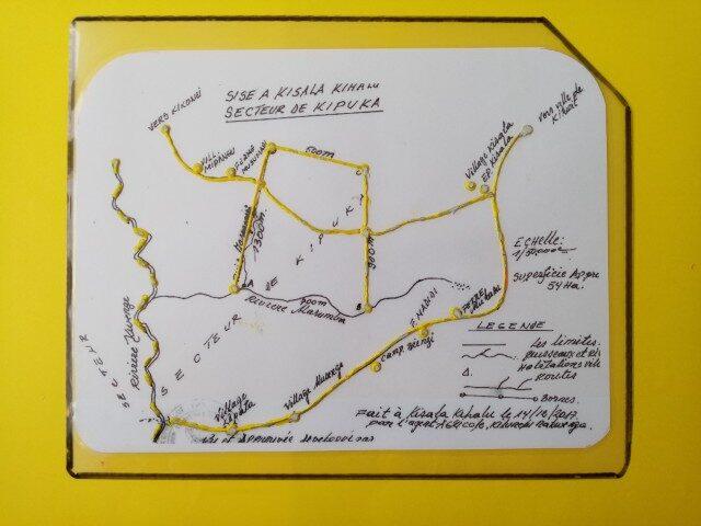 A laminated map with tactile markings. The upper right corner is cut off. This enables the user to understand how to hold the map in the correct direction.