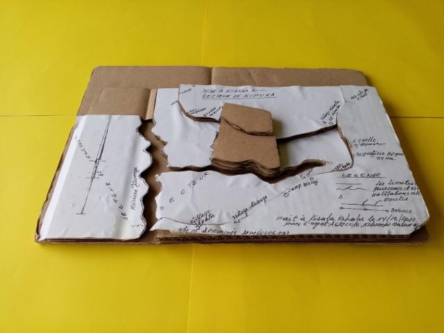 A4 print of the map on paper, laid on top of cardboard. The cardboard is cut with the roads and rivers as a division.