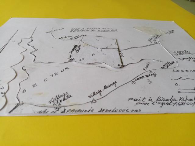 A4 print of the map on paper. Multiple layers of paper are laid on top of each other. The paper is cut with the roads and rivers as a division.