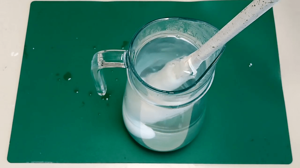 The cane is dipped into a vase filled with hot water.