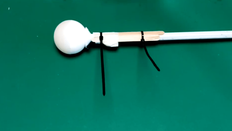 The cane tip is attached to the cane with the popsicle sticks and two cable ties.