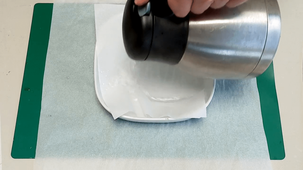 Water is being added to the tray with baking paper.