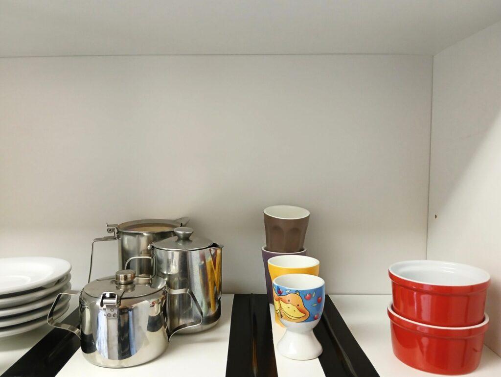 The end result. A neatly structured cupboard thanks to using tape as a divider for each type of object.