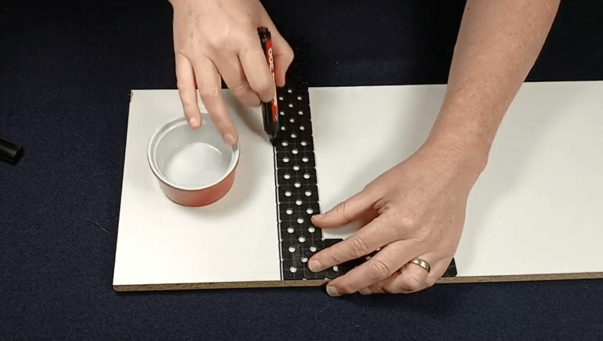 Marking where we want the centre of the tape by using a straight edge and a thick marker.