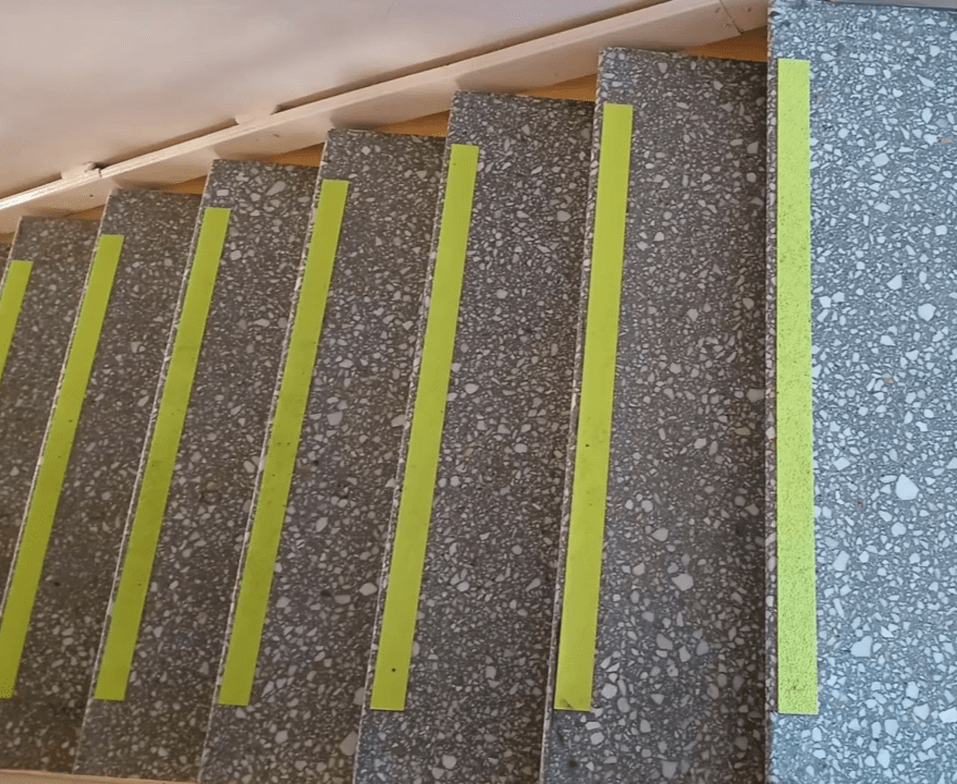 Using a yellow, anti slip tape along each step of our grey staircase. By doing so we highlight a potential danger.
