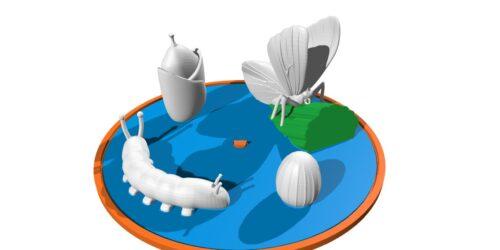 On top of a disk there are four models, each representing a butterfly's life cycle: egg, caterpillar, and chrysalis and butterfly