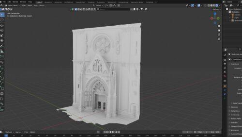 he original model of the cathedral. The model is highly detailed with intricate Gothic architectural elements. Central to the design is a large pointed archway adorned with decorative arches and miniature statues. Above the entrance is a rose window featuring floral patterns. Positioned symmetrically on both sides of the rose window are additional smaller spires and decorative features.