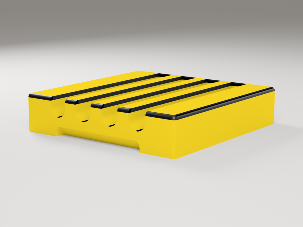 EN: Side view of the yellow pen holder showing the four rounded grooves and the grip notch at the bottom. DE: Seitenansicht des gelben Stifthalters mit den vier runden Mulden und der Griffmulde an der Unterkante.